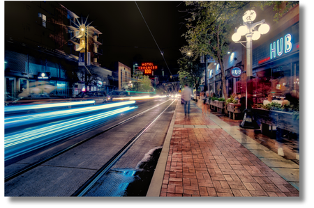 Congress street in downtown Tucson at night with business and car lights