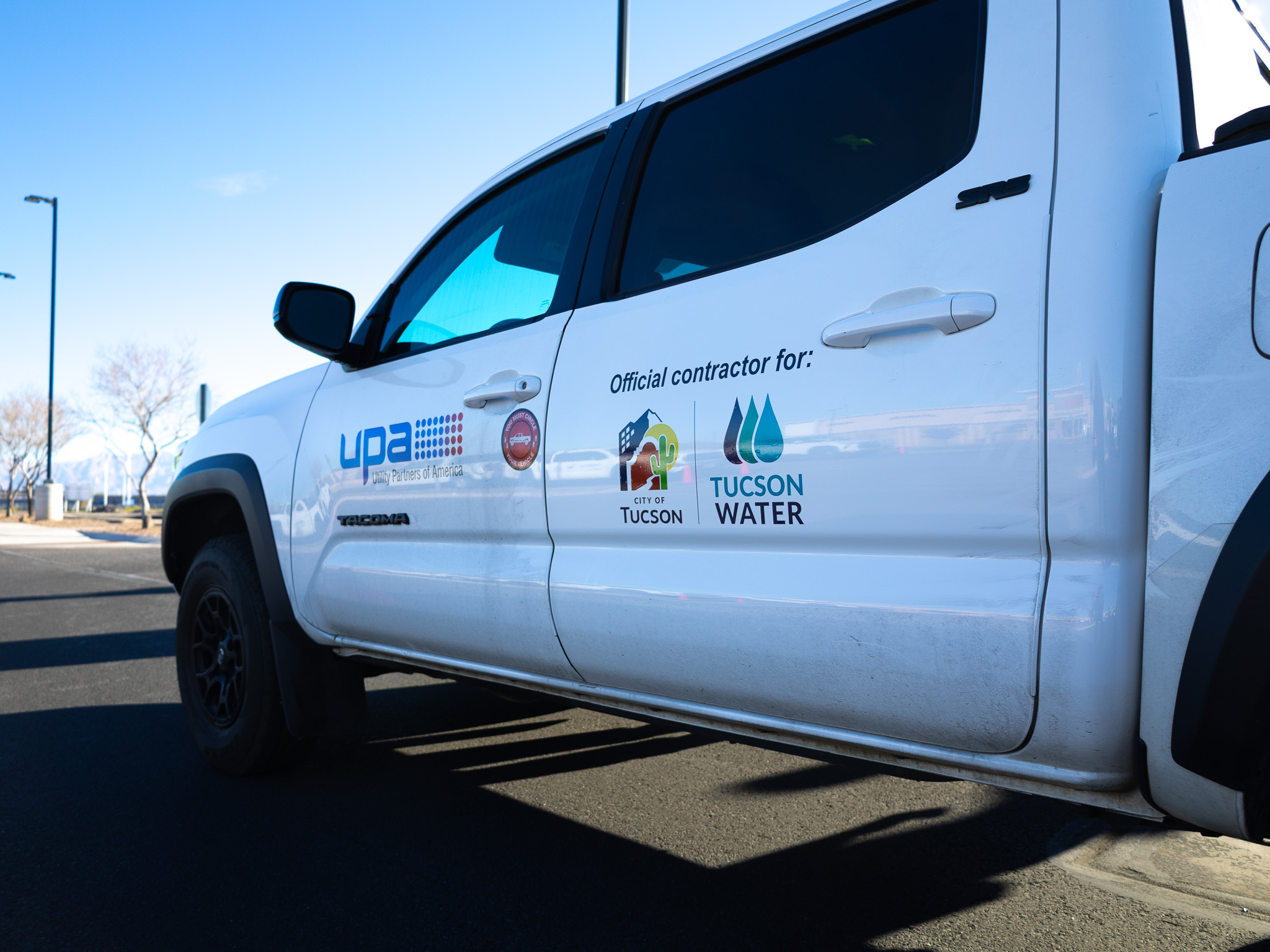 Tucson Water and Utility Partners of America logos on a truck
