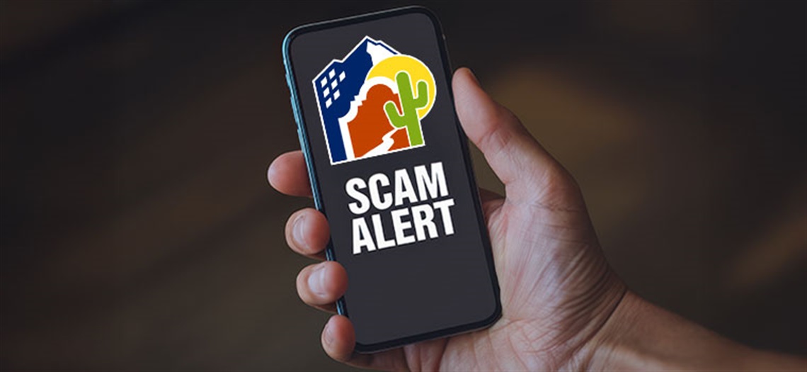 Cell phone with city log saying scam alert