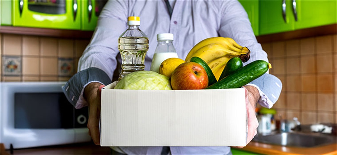 Picture of man holding a food box