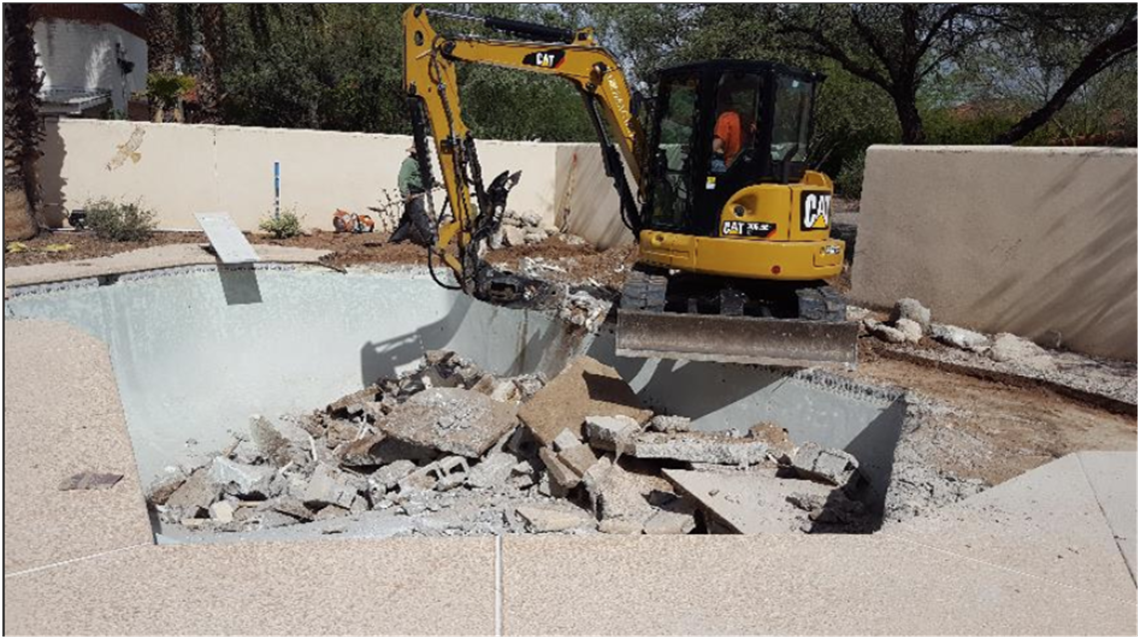 Photo of a pool being demolished.