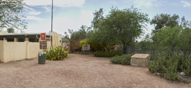 A small stone wall with a modest altar positioned in front, creating a serene and contemplative atmosphere.
