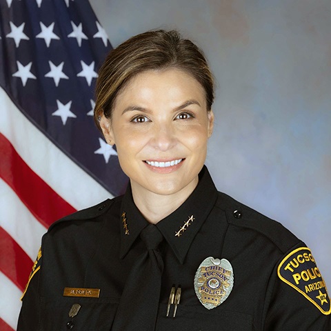 Department portrait of Chief Monica Prieto in uniform in front of an American flag.